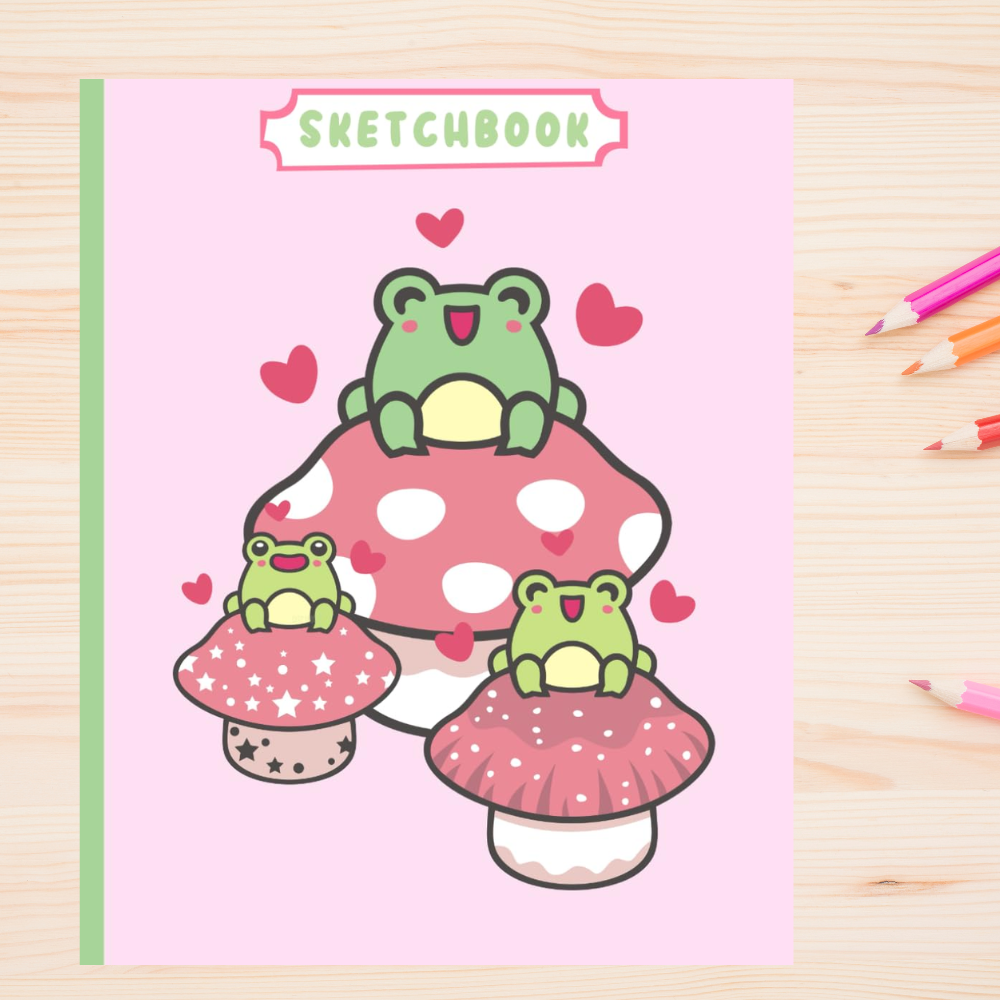 Colorful children's sketchbook cover featuring three cartoon frogs sitting on vibrant mushrooms, surrounded by floating hearts, on a pink background with pencils laid out to the side.